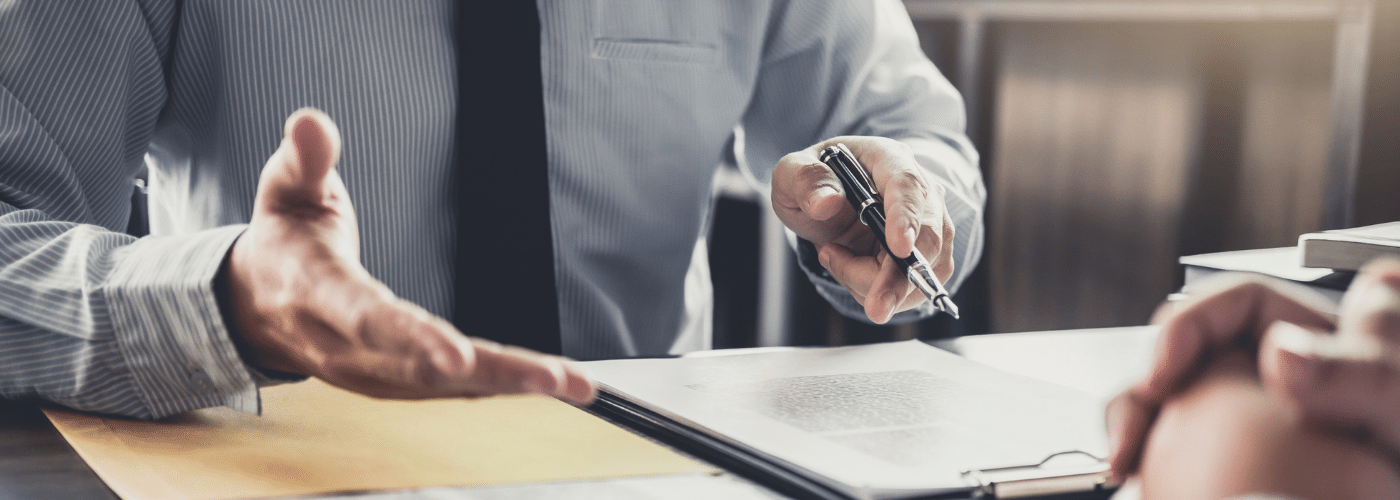 man in a suit with a pen in his hand