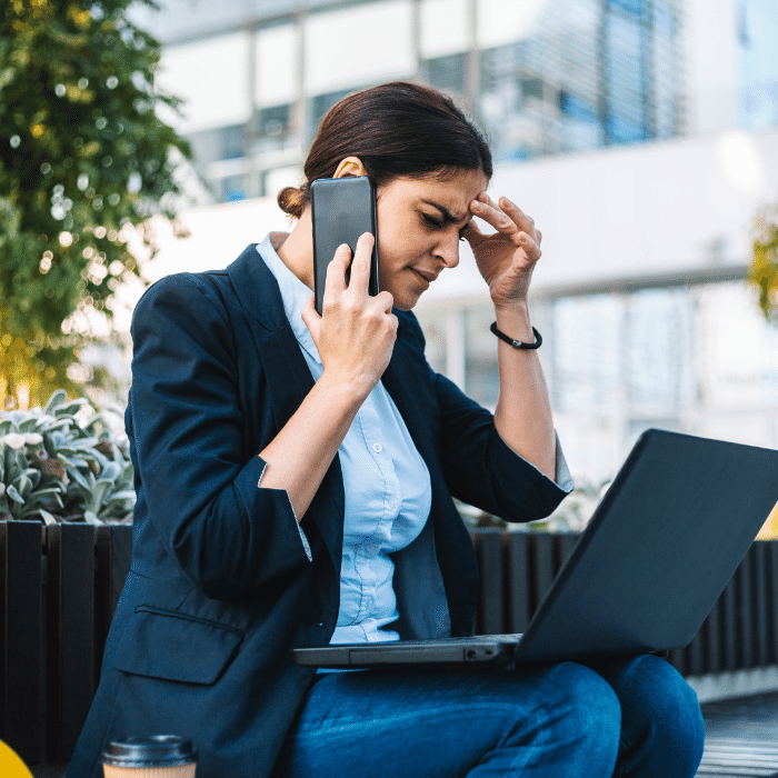 professional woman on the phone with a laptop on her lap